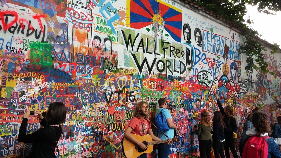 Летом для туристов играют музыканты у стены Джона Леннона